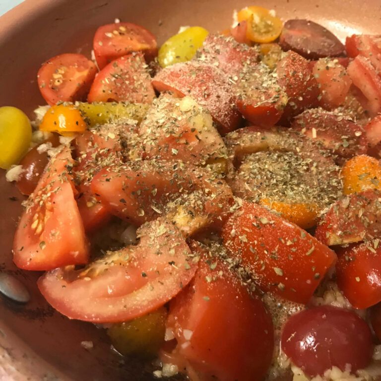 tomatoes and salt and pepper in skillet with oil and garlic