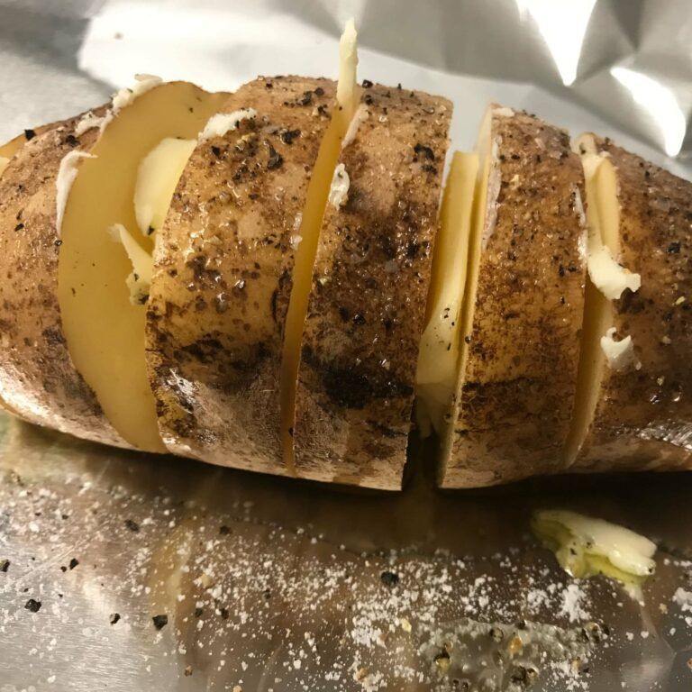 sliced potato with butter in between slices