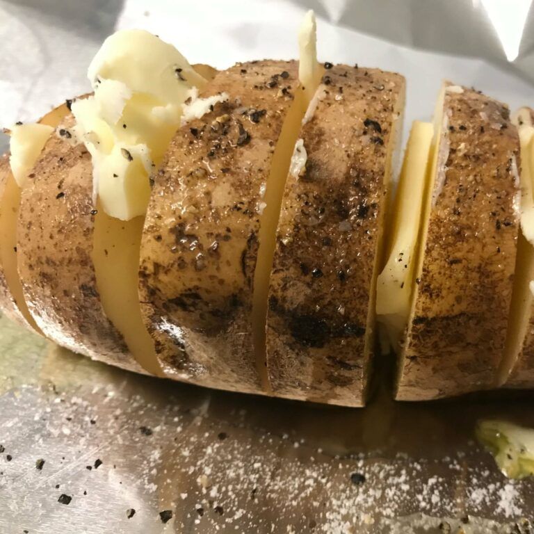 sliced potato with butter in between the slices