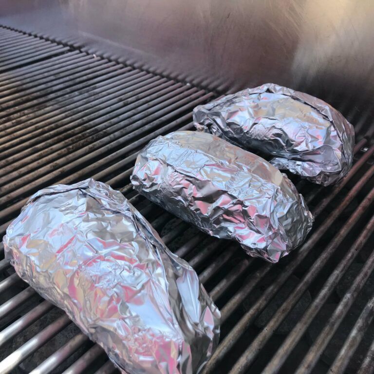 potatoes wrapped in foil on the grill
