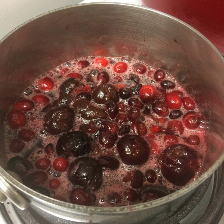 fruit boiling in a pot on the stove.