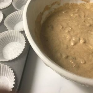 bowl of batter next to muffin tin