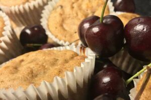 muffins and fresh cherries in a basket