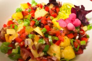 bowl of kiwano salsa with fresh flowers