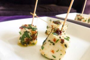 Marinated Mozzarella Cubes with toothpicks on a plate