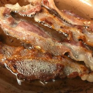 bacon cooking in a skillet