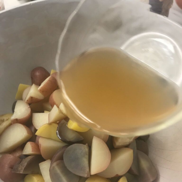 pouring stock over potatoes