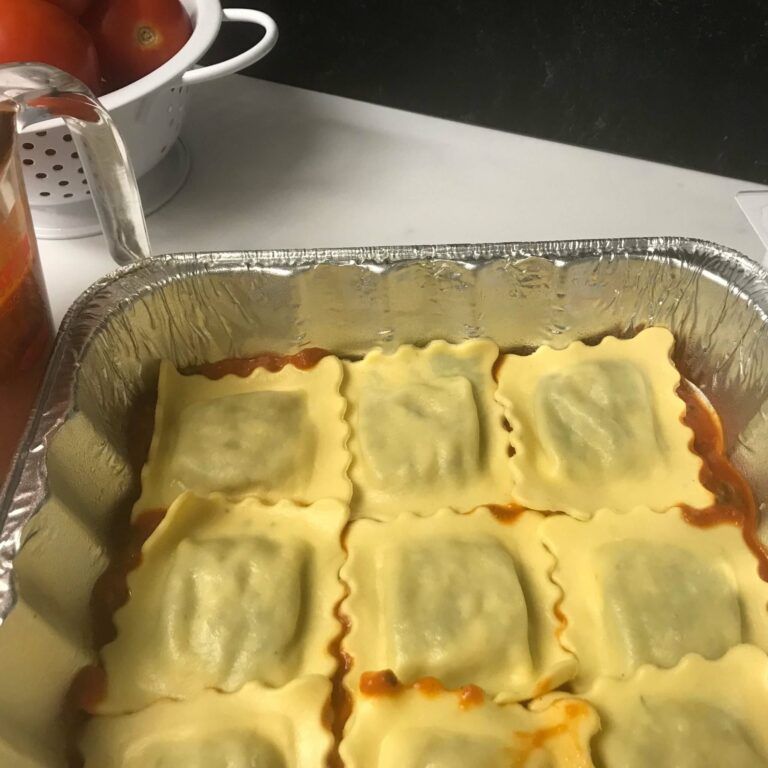 a whole layer of ravioli over sauce