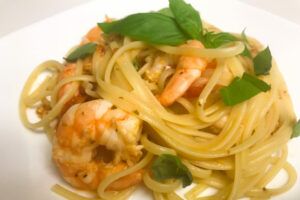 a bowl of linguine with shrimp and fresh tomato sauce