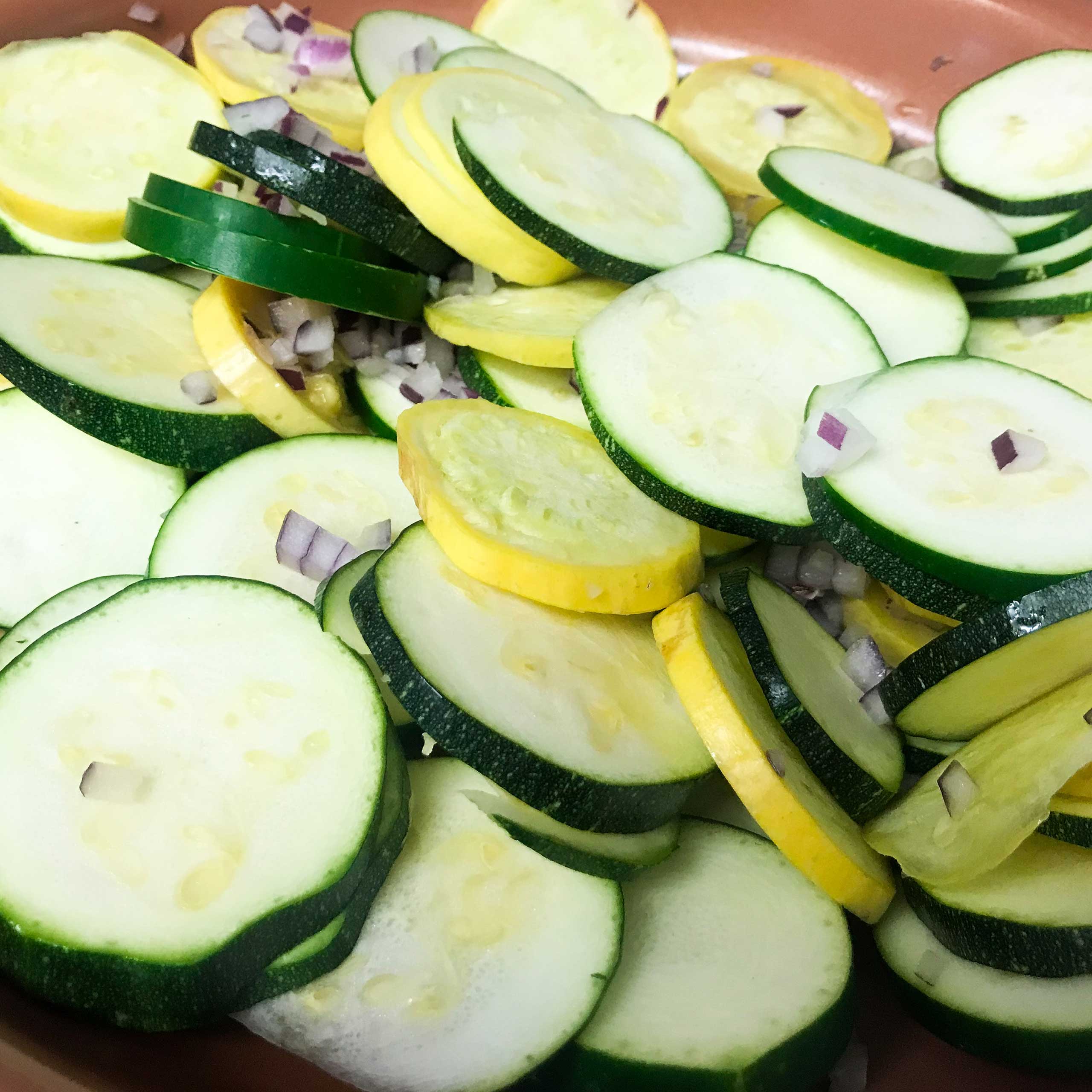 sliced zucchini and onion in a skillet