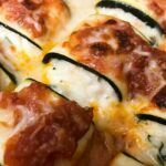 Zucchini lasagne roll ups cooked in a pan