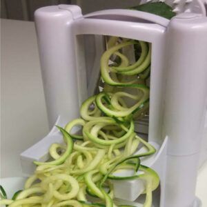 spiralizer machine with zuchinni spirals coming out of it