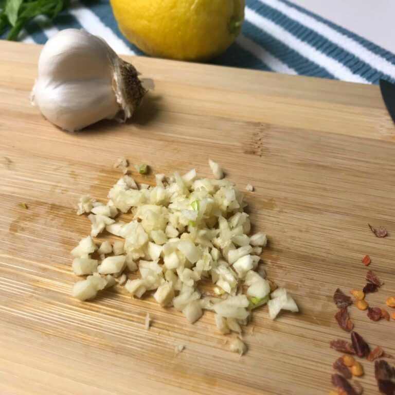 cutting board with chopped garlic