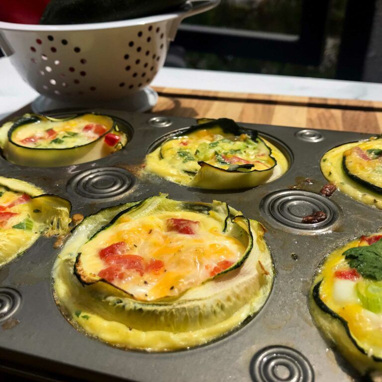 cooked zucchini egg cups in a muffin tin