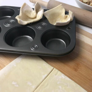 puff pastry squares pressed into muffin cups.