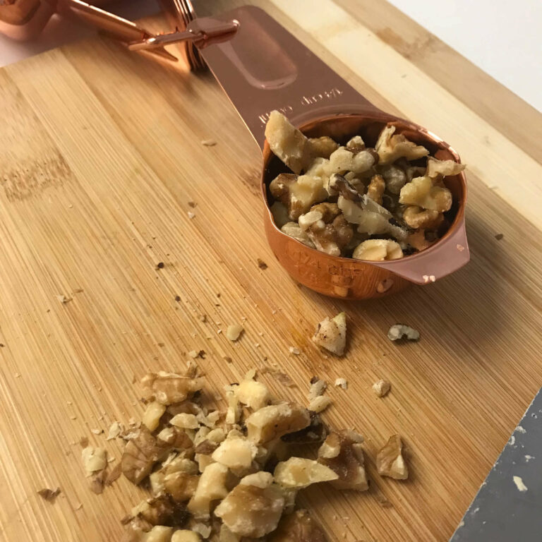 chopped walnuts on cutting board.