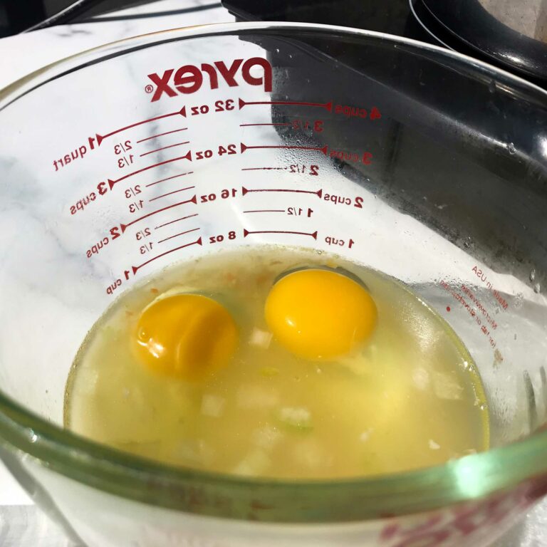 two eggs in cup of broth