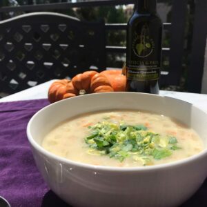 bowl of soup on table with pumpkins