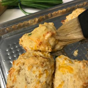 brushing biscuits with garlic butter