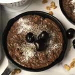 skillet of brownie topped with cherries