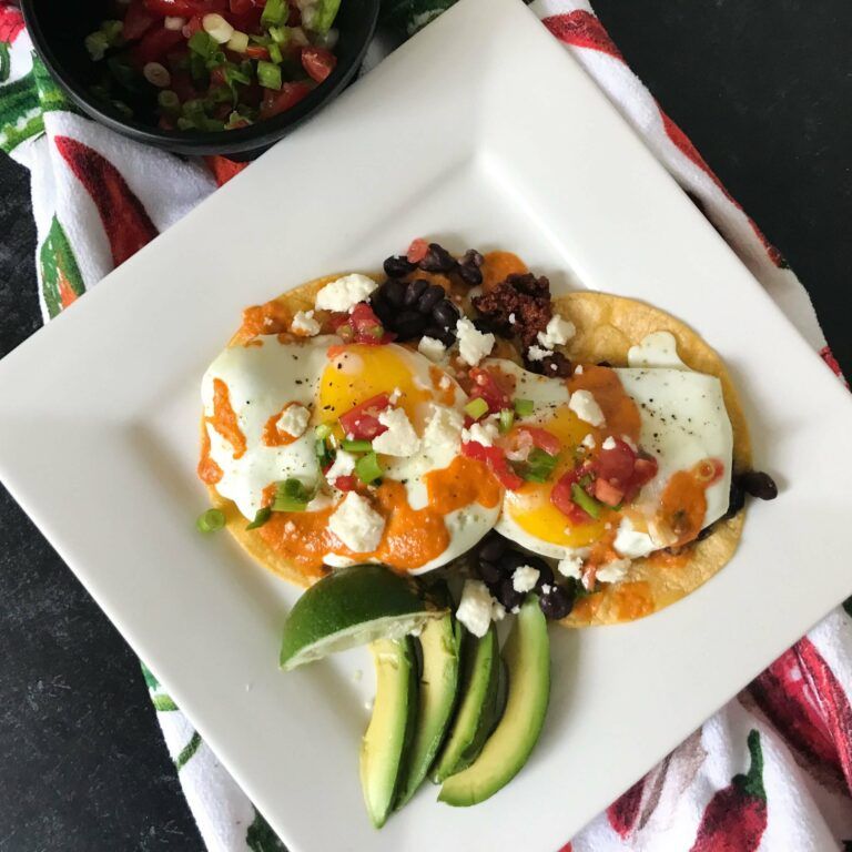 huevos rancheros plated with sunny side up eggs