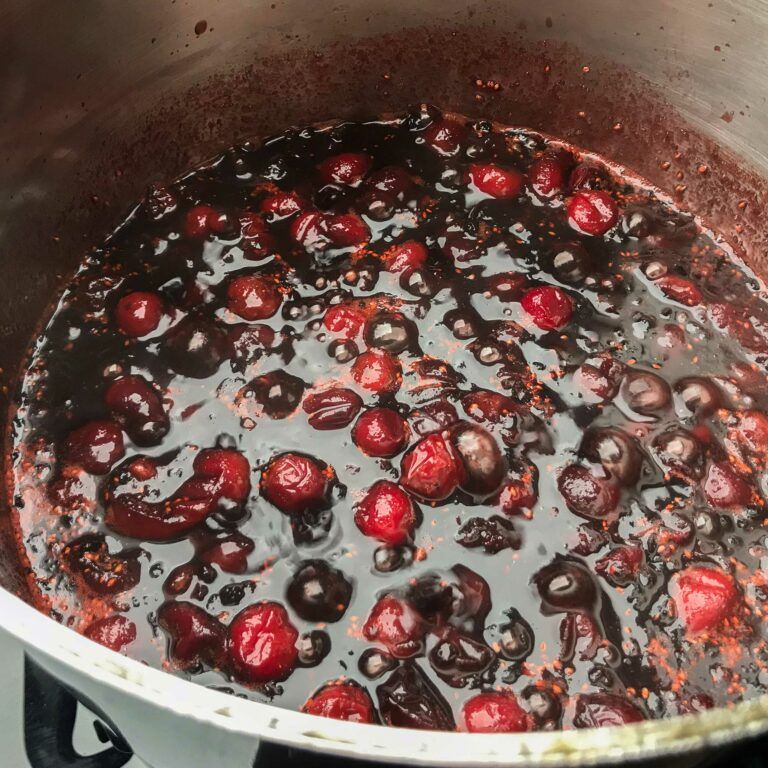 cooked cranberries and elderberries in a pot