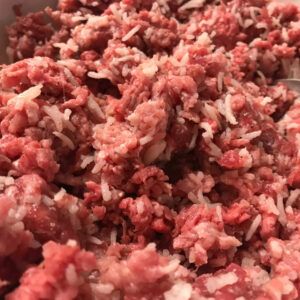 ground meat mixed with rice in a bowl