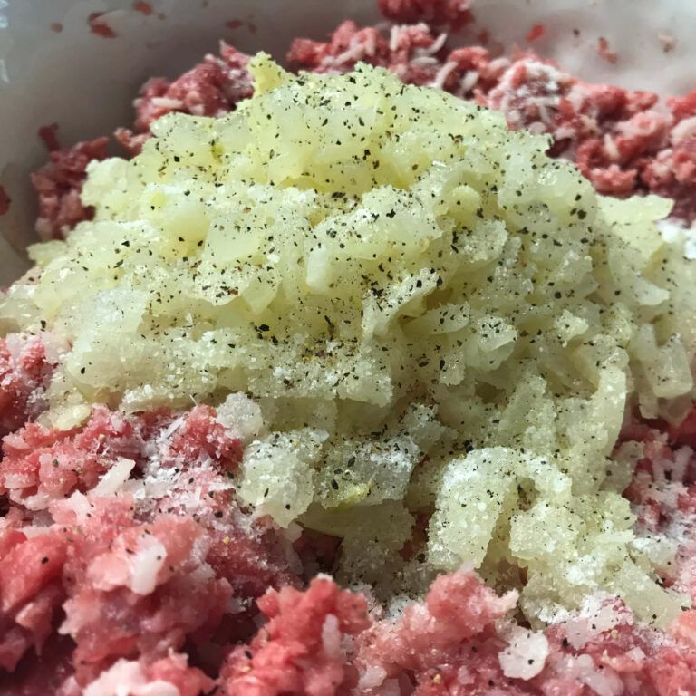 onions in meat mixture in a bowl