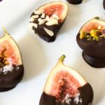 chocolate dipped figs on a platter
