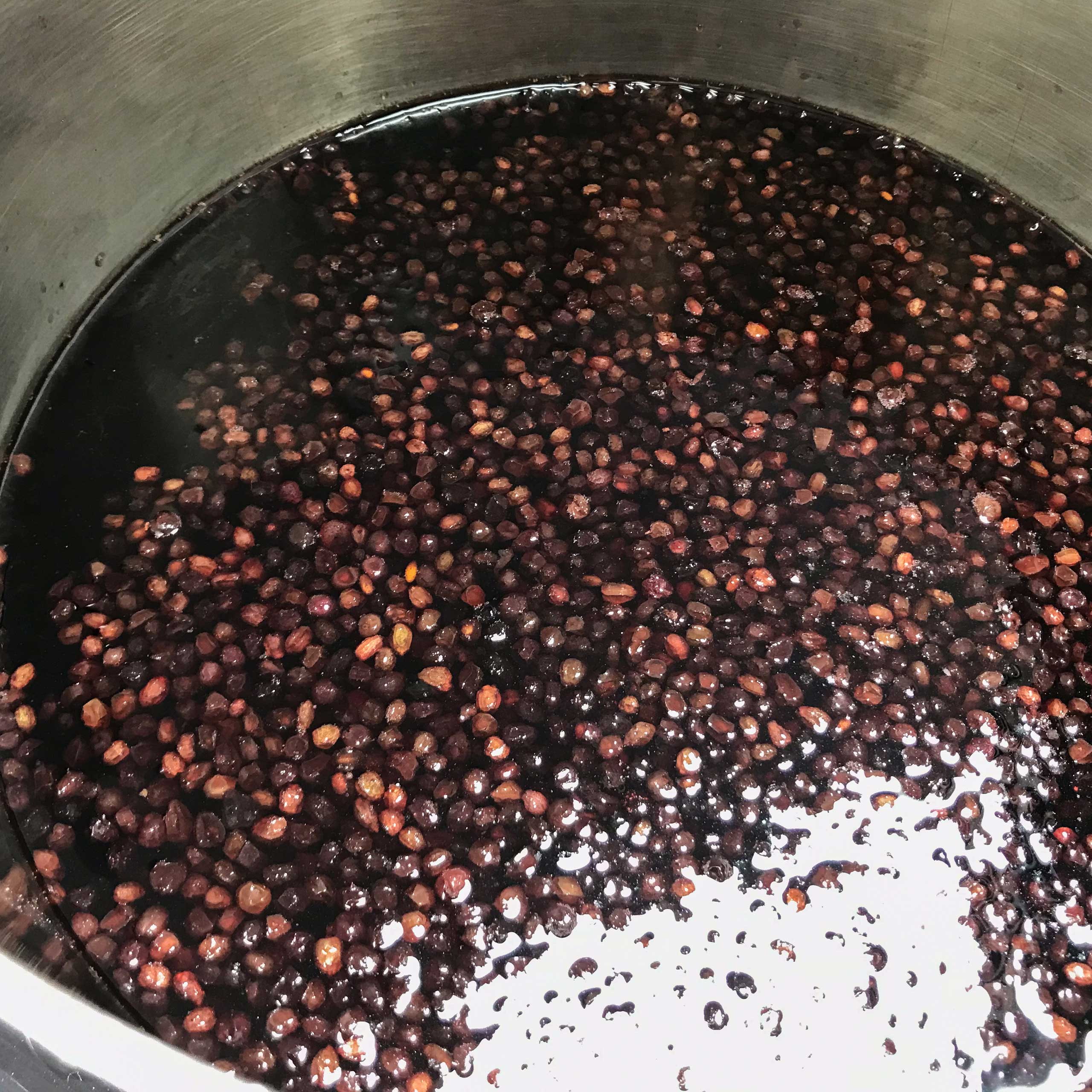 elderberries and liquid in pot