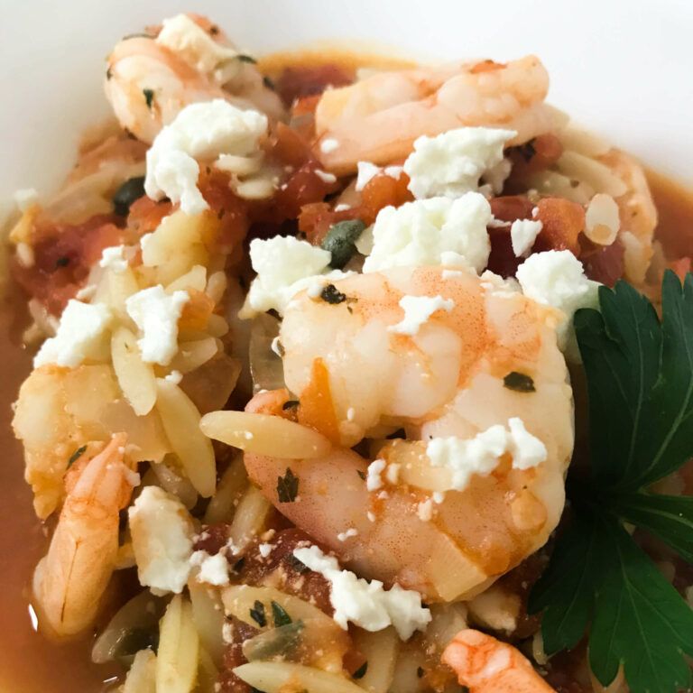 Greek style shrimp feta and orzo in a bowl.