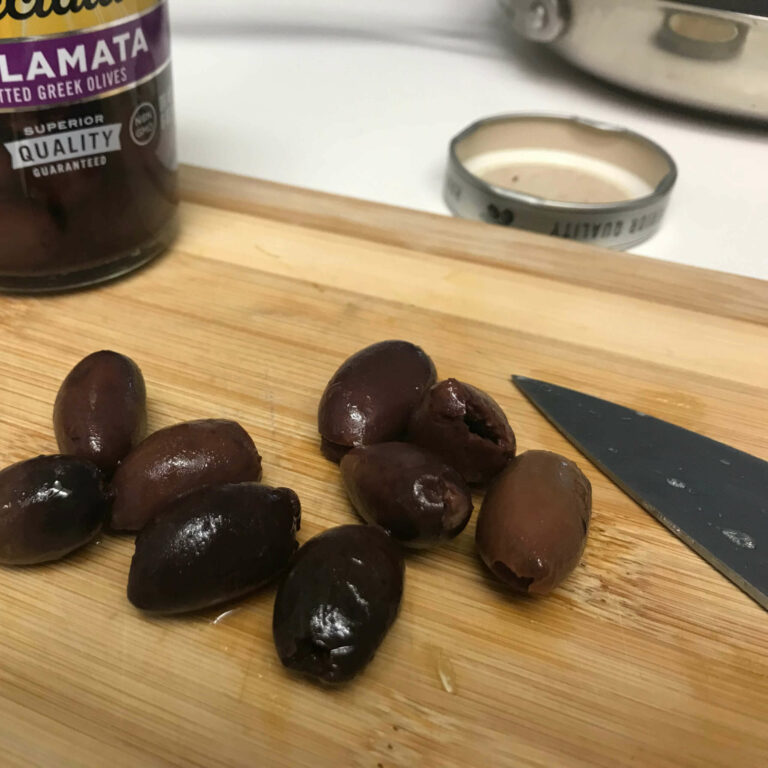 kalamata olives on a chopping board