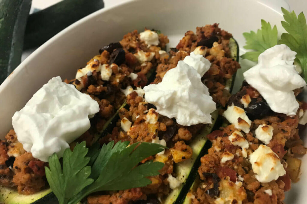 Greek turkey zucchini canoes in a dish