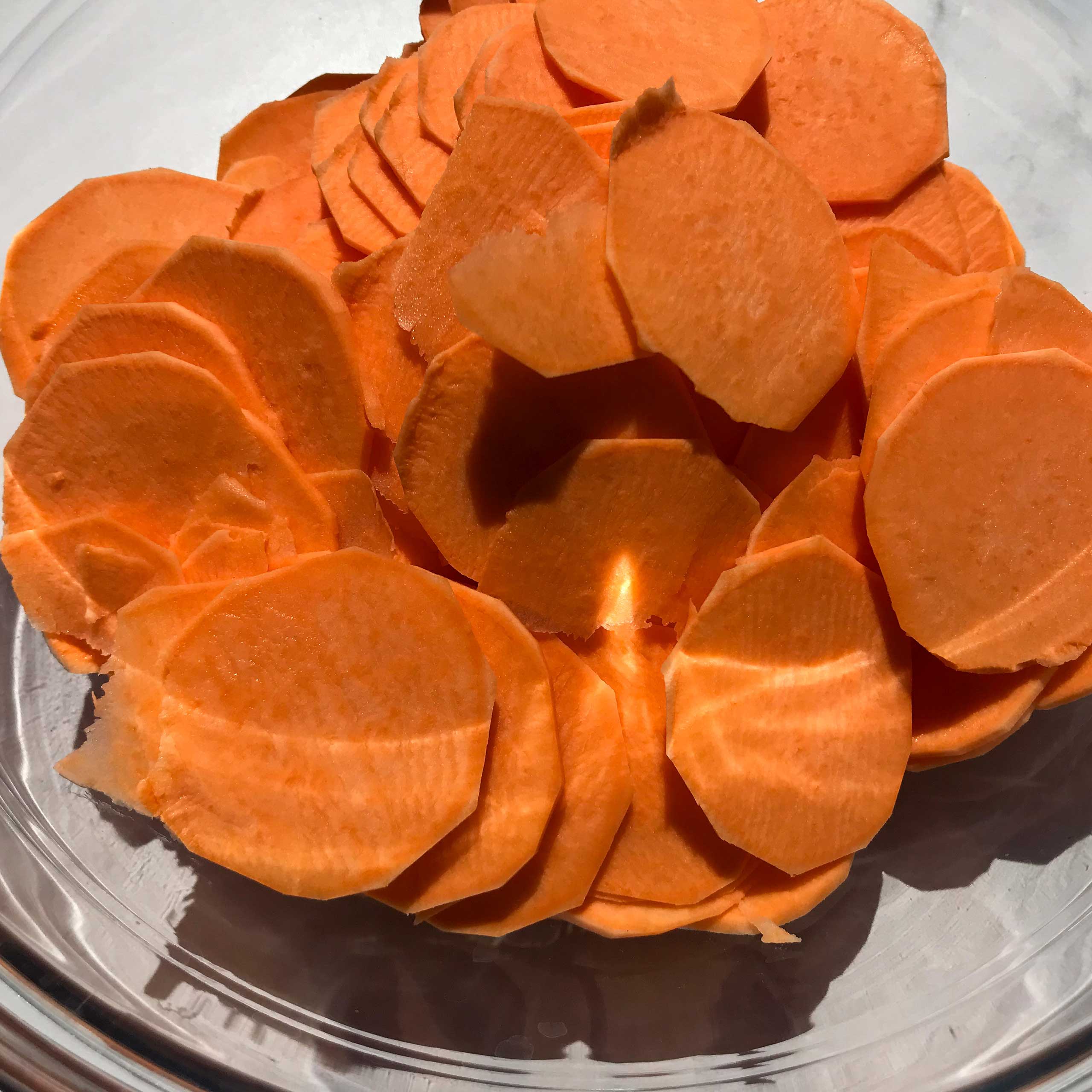 sliced raw sweet potatoes in a bowl