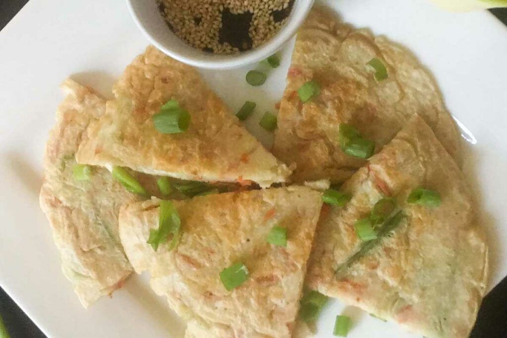 vegetable pancakes and dipping sauce on a plate