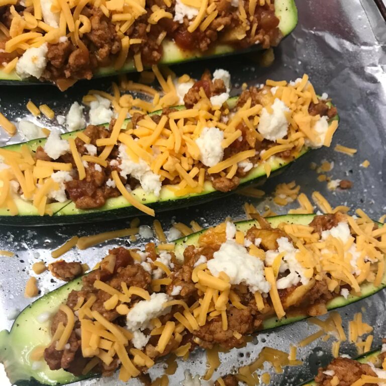 stuffed zucchini with cheese on top ready for broiler