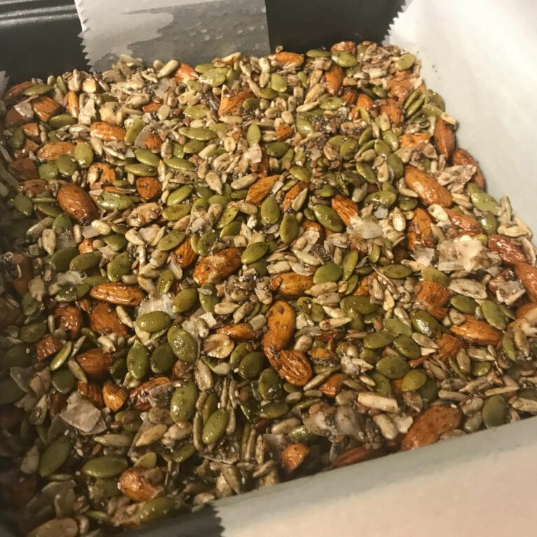 nuts and seeds are pressed into pan