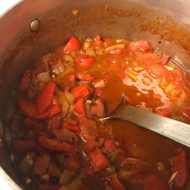 tomatoes and bell pepper cooking in a pot