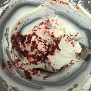 raspberry and cream cheese mixed in bowl.