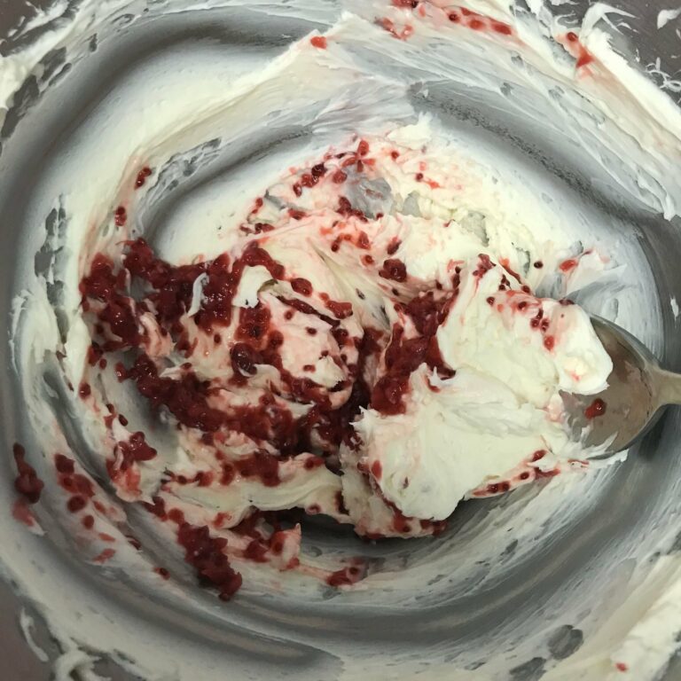 raspberry and cream cheese mixed in bowl.