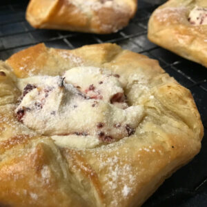 baked danish topped with powdered sugar.