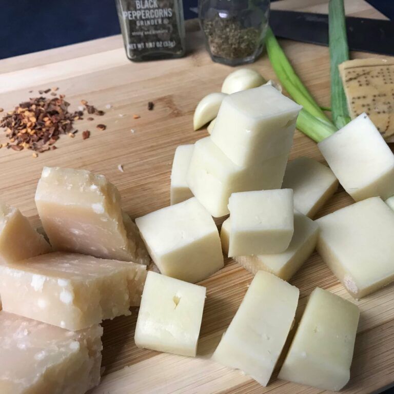 chunks of cheese on a cutting board