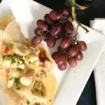 seafood crepes and grapes on a plate