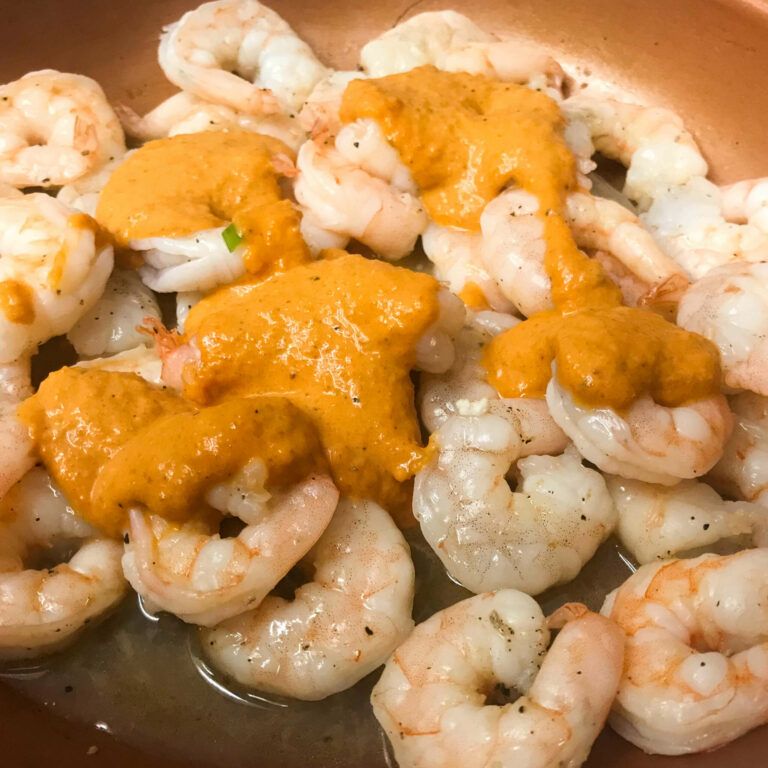 shrimp cooking with ranchero sauce in skillet