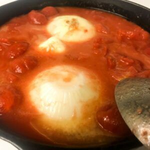 onion in a skillet of tomato sauce