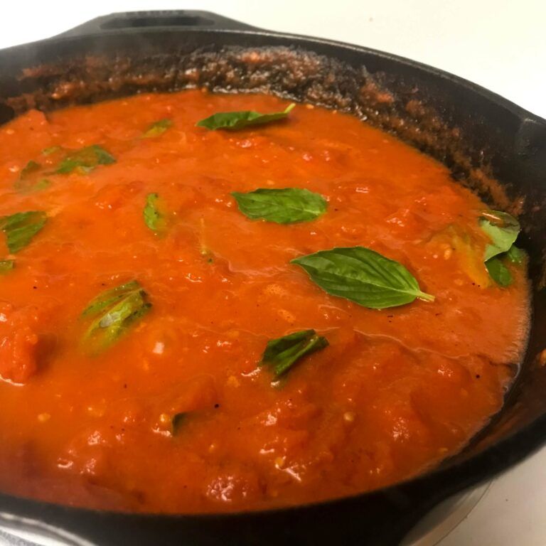 skillet of tomato sauce with basil