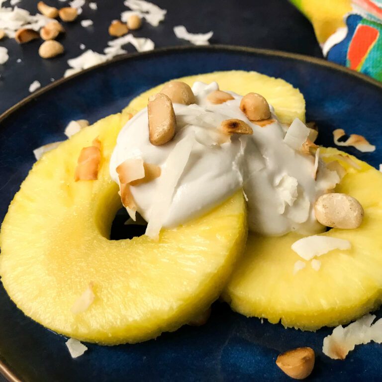pineapple, coconut cream, coconut and macadamia nuts on a plate