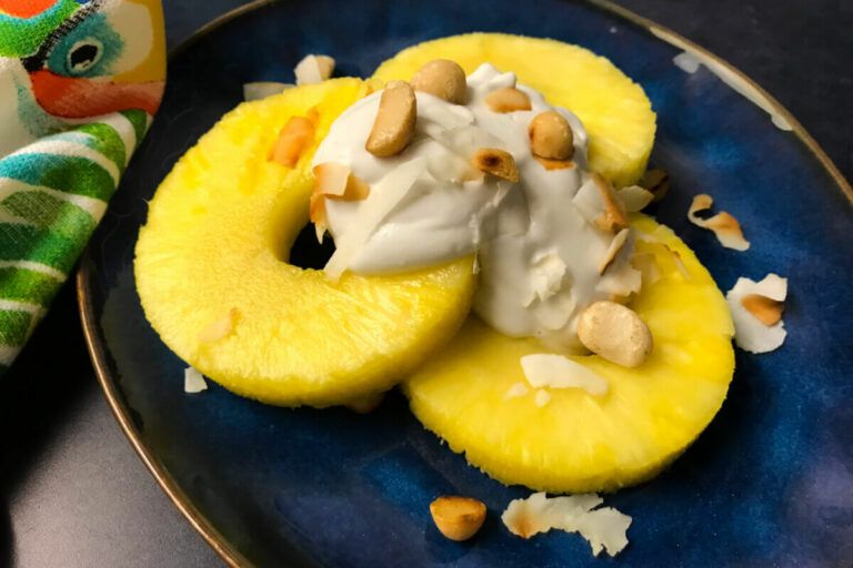 pineapples with coconut cream and nuts on a plate