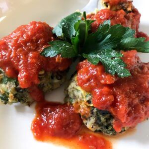 three meatballs with marinara sauce and parsley