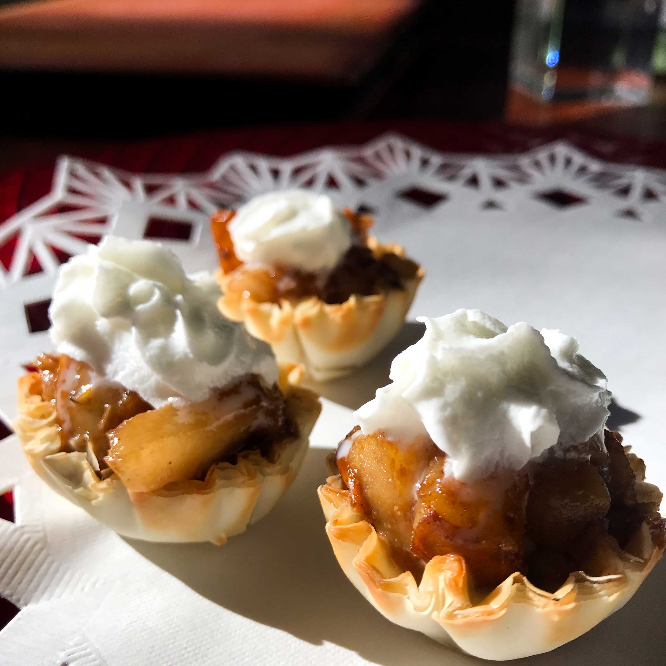 three balsamic pear and macadamia bites on a plate.